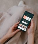 woman holding Your Daily app check in page (1) woman holding Your Daily app check in page (1)